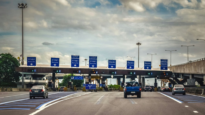 Vehicles passing through electronic toll collection lanes at a highway toll plaza